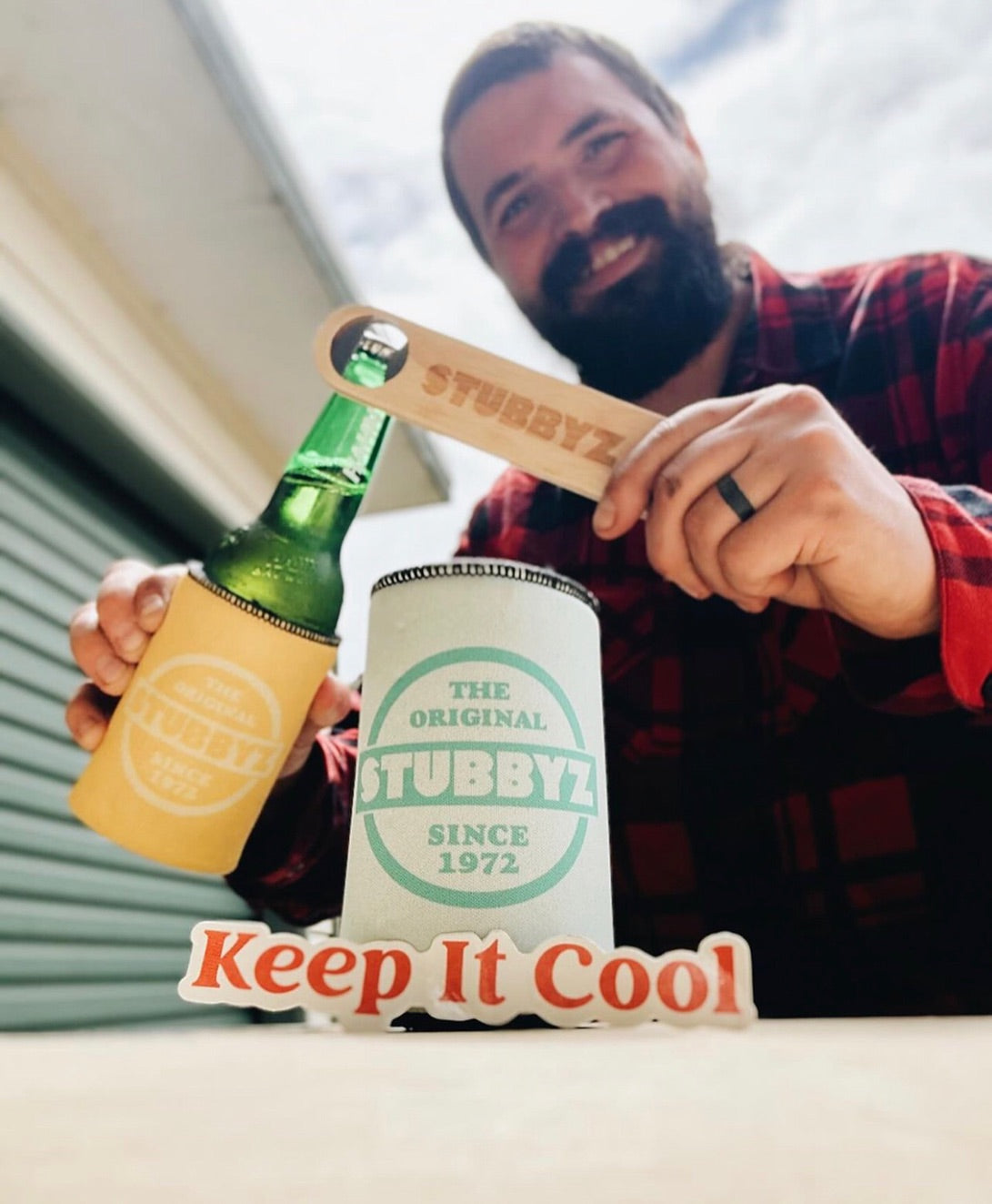 A man opening a beer with a Stubbyz bamboo bottle opener